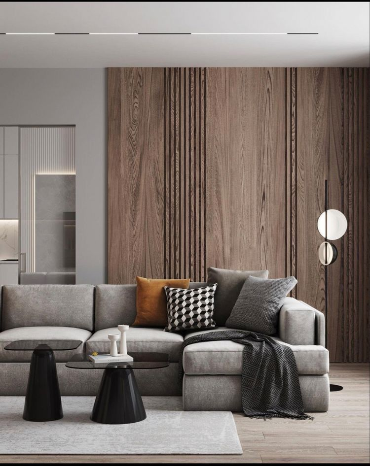 Luxury living room with walnut panelled wall and grey sectional sofa
