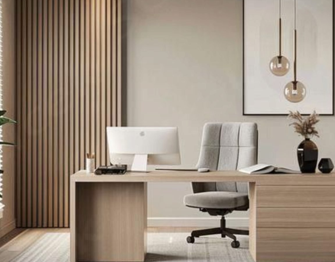 Light oak desk with a grey office chair and slatted wood wall