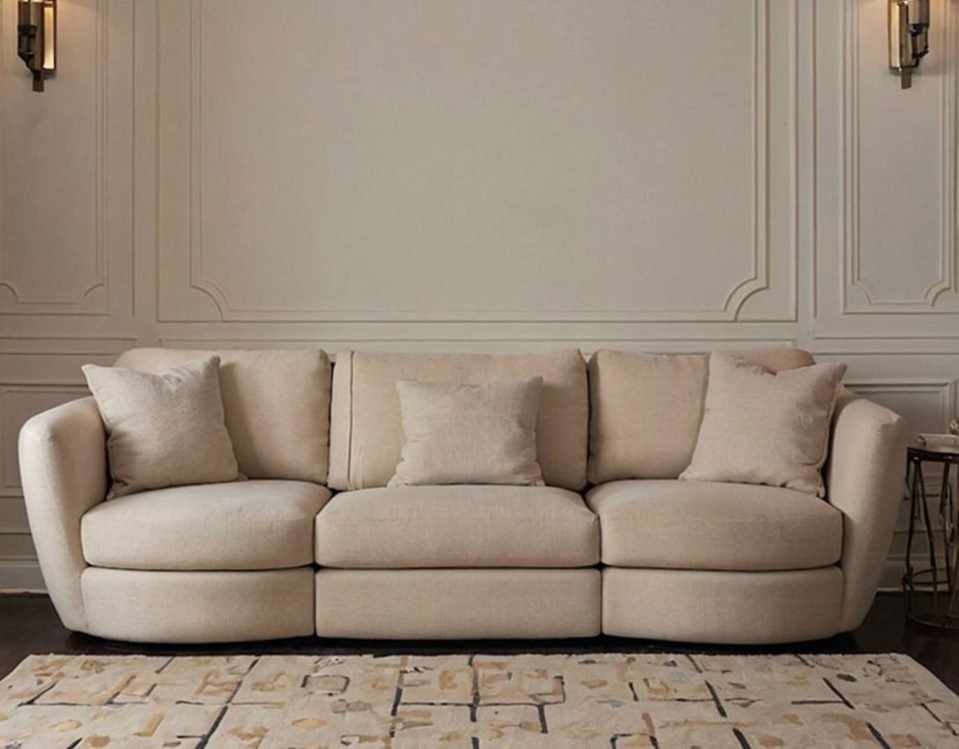 Cream sofa on a patterned rug in a panelled living room